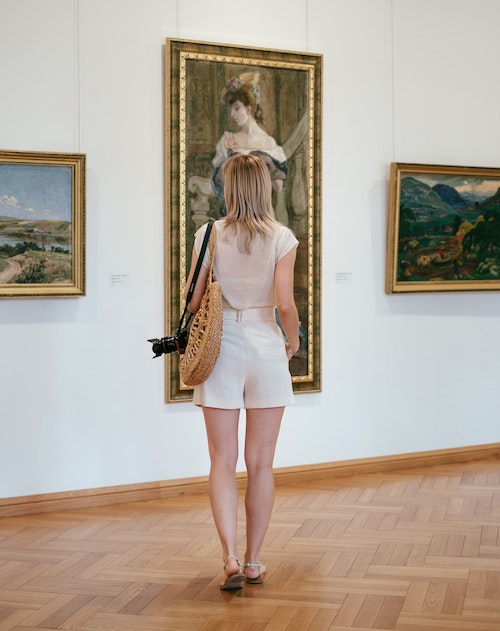 Lady looking at an art collection using art hanging system